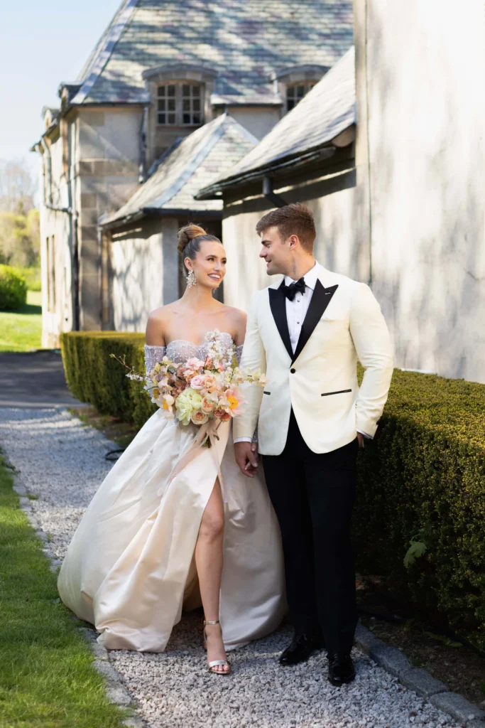 Couple walking along the front path at a coastal estate in Rhode Island 